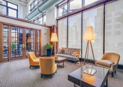 Industrial-chic community amenity space at The Packard apartments in Center City with floor to ceiling windows