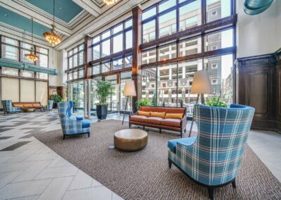 Grand two-story lobby featuring mahogany woodword and restored architectural elements at The Packard Motor Car Building apartment complex in Center City