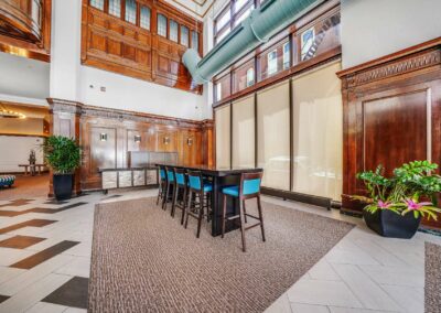 Restored Packard Motor Car Building lobby with restored mahogany woodwork and factory-chic decor turned into an apartment building in Center City.